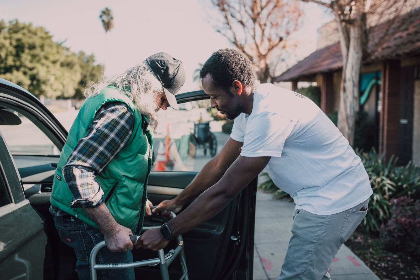 A Keystone caregiver helping a senior client with his walker